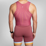 Rear view of a model wearing a maroon athletic unisuit with a yellow sunburst pattern on the back with yellow and white stripes at the hem of the trou.