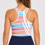 A woman shown from the back wearing a racerback athletic unisuit. The top has a multicolor striped pattern in pink, orange, blue, and white, while the shorts are navy blue with light blue and white trim at the hem.