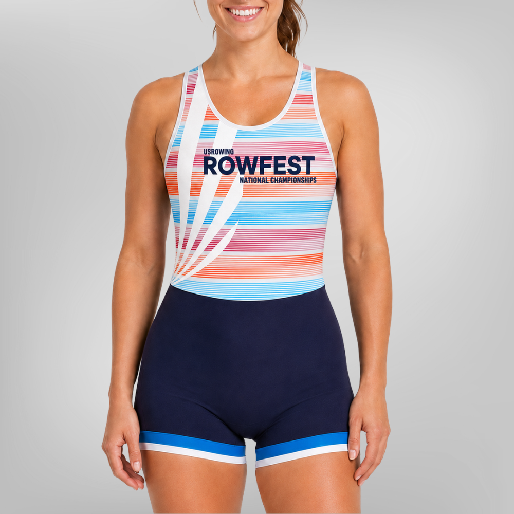 A woman modeling a one-piece rowing uni with a white base, multicolor pastel stripes, and navy blue shorts with blue and white trim. The front of the top features the text 'SEMINING ROWFEST NATIONAL CHAMPIONSHIPS'.