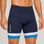 A close-up of a male model wearing navy blue rowing trou with a white and blue stripe at the hem and a white USBiking logo on the left leg, set against a plain light gray studio background.